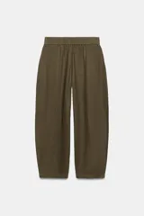 Pantalón de lino marrón oscuro, de corte barrel con pernera holgada que se estrecha hacia el tobillo, cintura elástica y bolsillos delanteros.