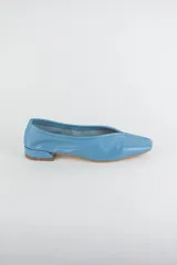 Mocasines de cuero metalizado color gris, con diseño de punta cuadrada y costura central fruncida en la capellada.