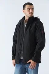 Campera negra para hombre con capucha ajustable y bolsillos con botones.