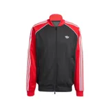 Campera deportiva Adidas SST de corte holgado, confeccionada en tejido de malla color negro con mangas rojas y detalles de franjas blancas características de la marca. Cuenta con cuello tipo bomber, cierre frontal completo y logo del trifolio bordado en el pecho.