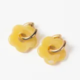 Aros tipo argolla dorada con dije colgante en forma de flor de resina color amarillo.