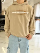 Hoodie de corte boxy fit color gris, con capucha y estampado frontal con la leyenda "Duxon Creative Studios".