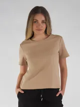 Remera blanca de manga corta, cuello redondo con detalle de costura decorativa a tono, y bordado frontal a tono.