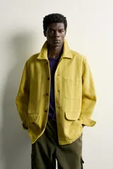 Sobrecamisa de algodón con efecto lavado, corte relaxed fit, cuello solapa, manga larga, bolsillos frontales tipo parche con solapa y cierre de botones oscuros.