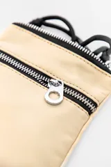 Bandolera pequeña color fucsia con correa ajustable negra. Cuenta con un compartimento principal con cierre y dos bolsillos frontales con cierre.