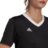 Remera deportiva Adidas de mujer, color negro con cuello en V blanco y logo de la marca en el pecho.