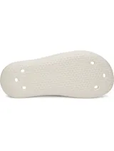 Sandalias de una sola pieza moldeadas en EVA, color blanco, con diseño ergonómico, orificios de drenaje y suela texturizada para mayor tracción.