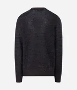 Suéter de punto texturizado bicolor con cuello redondo y mangas largas. Presenta un diseño de tejido con relieve y puños acanalados.