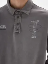 Chomba de manga larga en algodón con efecto lavado, cuello polo clásico con cartera de botones y estampados gráficos en el pecho.