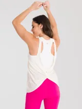 Musculosa deportiva de corte regular, color blanco, con cuello redondo y espalda rebajada. Confeccionada en tejido de secado rápido, ideal para actividades físicas.