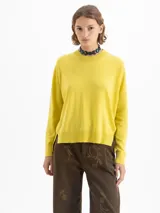 Sweater amarillo de lana merino y algodón, de largo hasta la cadera, con mangas largas y silueta holgada.