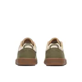 Zapatillas Merrell modelo Cygnet Canvas, color verde militar con una gran letra "M" blanca en el lateral y suela de goma marrón.