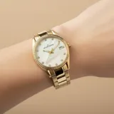 Reloj analógico Jacques Lemans línea Derby con caja y malla de acero inoxidable en tono dorado. Esfera de nácar con indicadores de hora de cristal Swarovski, manecillas doradas y ventana de fecha.