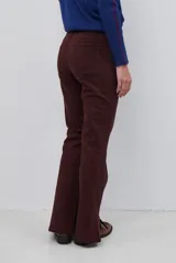 Pantalón tipo jean de corte recto y tiro medio, color burdeos, con costuras a tono y abertura lateral en el ruedo.