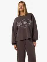 Buzo color chocolate brown con estampado frontal que dice "PARIS AVENUE MONTAIGNE Luxury Fashion". Tiene puños y ruedo acanalados.