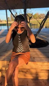 Musculosa negra de gamuza con bordados blancos en la parte delantera.