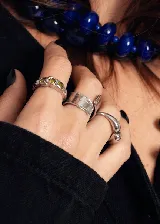 Anillo abierto de acero quirúrgico con diseño de superficie irregular y acabado brillante.