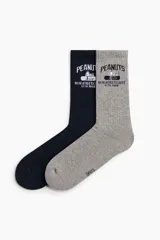 Pack de dos pares de medias de caña alta acanaladas, una en color azul marino y otra en gris melange, con diseño estampado de Snoopy y texto alusivo a Peanuts.