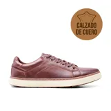 Zapato casual de cuero color marrón con cordones y suela blanca.