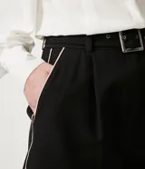 Short negro de tiro alto con cinturón, trabillas en la cintura, pliegues y bolsillos.