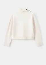 Jersey de punto medio color blanco, con cuello perkins y detalle de botones metálicos en el hombro izquierdo.