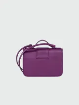 Bandolera Longchamp modelo Box-Trot XS, color morado, con correa fina al hombro y logo circular en el frente.