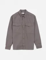 Camisa gris de manga larga con cuello clásico, cierre frontal con botones, dos bolsillos de parche en el pecho y corte recto.