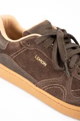 Zapatilla urbana de gamuza color marrón, con cordones al tono, suela de goma color caramelo y logo de la marca grabado en el lateral.