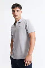 Remera polo de manga corta con textura tipo waffle, color marrón, con cuello clásico y logo bordado en el pecho.