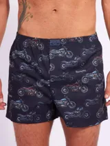 Bóxer de algodón blanco con estampado de flores pequeñas color celeste, con cintura elástica y logo de la marca en el centro.