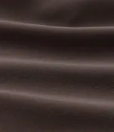 Bermuda deportiva gris con cintura elástica, cordón de ajuste, bolsillos con cremallera, recorte lateral con agujeritos y abertura en el bajo.