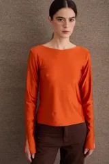 Remera de manga larga con cuello bote y aberturas en los puños, confeccionada en tejido liso.