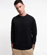 Buzo de algodón negro, sin estampa, con cuello redondo, mangas largas y puños ajustados.