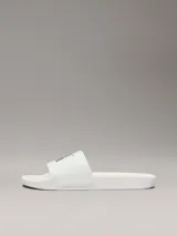 Ojotas blancas de Calvin Klein Jeans, con capellada de lona con logo estampado en negro.