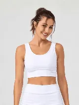 Top deportivo blanco de compresión media, con escote redondo, diseño alargado tipo musculosa y copas removibles.