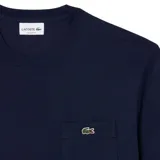 Remera de manga corta Lacoste, color blanco, con cuello redondo y el icónico logo del cocodrilo bordado en el pecho.