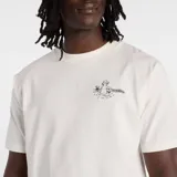Remera de algodón color blanco con cuello redondo y mangas cortas. Presenta un pequeño estampado gráfico en el pecho con diseño artístico.