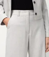 Pantalón de sastrería modelo wide leg, color gris claro, con cintura estructurada, bolsillos delanteros y traseros.