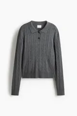 Remera polo de manga larga de punto trenzado gris, con cuello clásico, tapeta con botones y remates acanalados en puños y bajo.