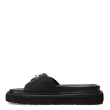 Sandalias planas Miss Carol modelo Milla, color negro, con una tira ancha en el empeine y una hebilla metálica grande en tono dorado. Cuenta con suela flatform dentada.