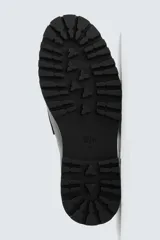 Mocasín de vestir negro, estilo penny loafer con antifaz en el empeine. Presenta forro y plantilla interior a tono, y suela track gruesa y dentada.