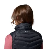 Chaleco acolchado negro con cierre frontal, cuello alto y bolsillos laterales con cremallera. Presenta un diseño híbrido con paneles laterales elásticos para mayor movilidad.