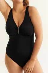 Malla entera negra con escote en V y aplique metálico dorado.