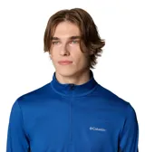Remera de manga larga Columbia con cierre frontal parcial, cuello alto y orificios para pulgares en los puños. Presenta un diseño técnico con paneles laterales en un tono de azul más oscuro y tecnología Omni-Wick para gestión de la humedad.