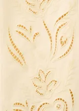 Jeans de tiro alto color beige con diseño recto, cinco bolsillos y detalles bordados calados en la parte inferior de las piernas.
