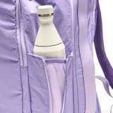 Mochila deportiva color lila, confeccionada en material textil con acabado ligeramente arrugado. Presenta un diseño funcional con compartimento principal amplio, bolsillo frontal con cierre, compartimento inferior independiente para calzado y bolsillos laterales. Incluye tirantes ergonómicos ajustables, asa superior y espaldera acolchada con diseño anatómico para mayor ventilación.