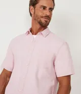 Camisa de hombre de manga corta, confeccionada en una mezcla de lino y algodón. Presenta cuello camisero, cierre frontal con botones y un bolsillo en el pecho.