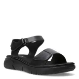 Sandalias de plataforma baja color negro, con tiras ajustables con velcro en el empeine y el tobillo. Presenta detalles perforados en la tira delantera y suela de goma con relieve.
