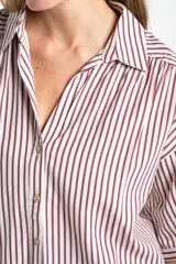 Camisa de corte oversize con estampado de rayas verticales, cuello clásico y mangas cortas. Presenta cierre frontal con botones y un diseño fluido y ligero.