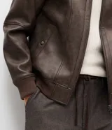 Campera de poliuretano con acabado lavado, diseño de corte regular, cuello camisero, cierre frontal, puños y cintura con rib elástico.